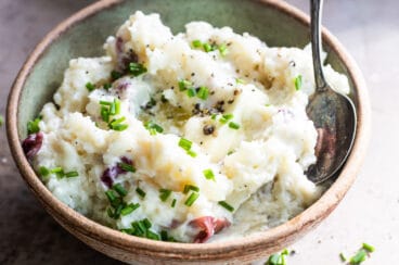 Boursin mashed potatoes in a light green bowl.
