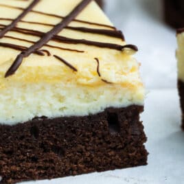 Cheesecake brownies on a white plate.