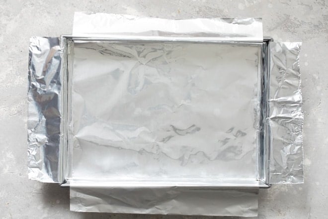 A cake pan lined with a foil sling.