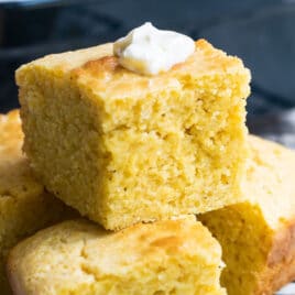Four pieces of cornbread on a cooling rack.