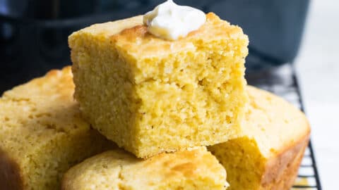 Four pieces of cornbread on a cooling rack.