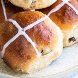 Hot cross buns on a gray platter.