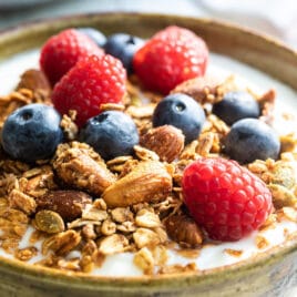 A yogurt parfait topped with berries and homemade granola.