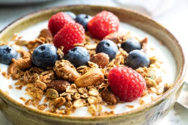 A yogurt parfait topped with berries and homemade granola.