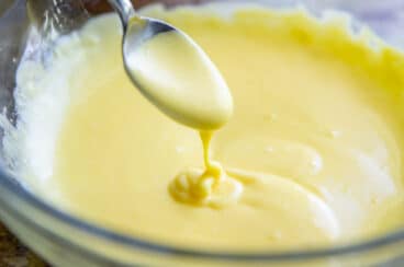 Making hollandaise sauce in a glass bowl.