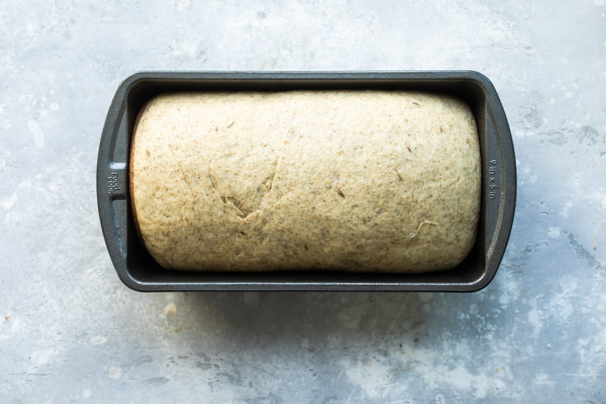 Unbaked bread in a loaf pan.
