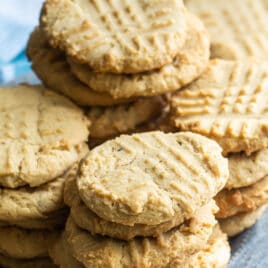 Peanut butter cookies stacked on a blue plate.