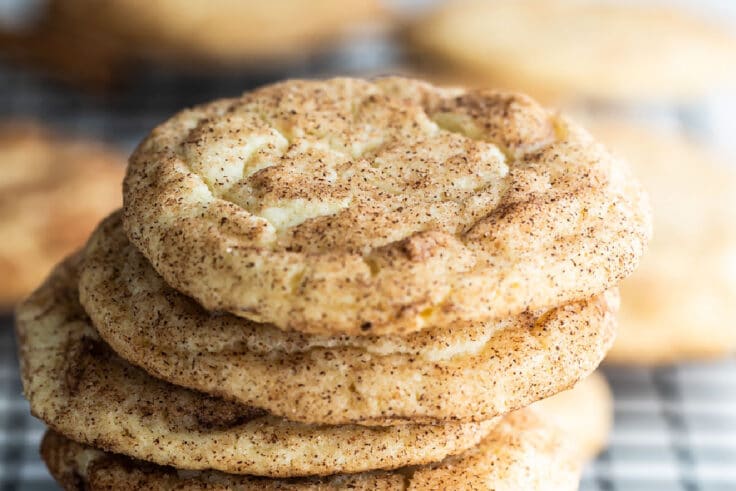 A stack of Snickerdoodle cookies on a baking rack.