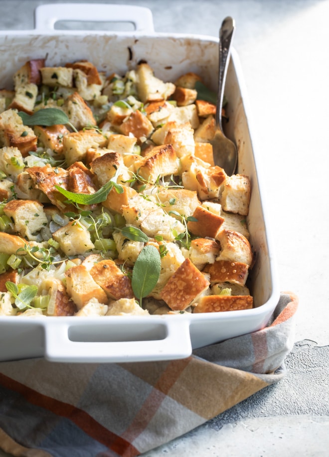 Classic bread stuffing in a white baking dish.