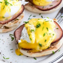 Eggs benedict on a white plate.