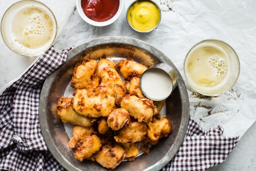An easy recipe for deep fried cheese curds for anyone not fortunate enough to live in or near Wisconsin. These crispy little bites are legendary in America’s Dairyland!