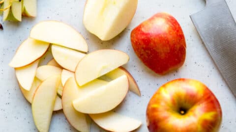 Apple slices on a cutting board.