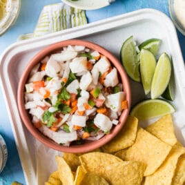Tilapia ceviche in a bowl with chips.