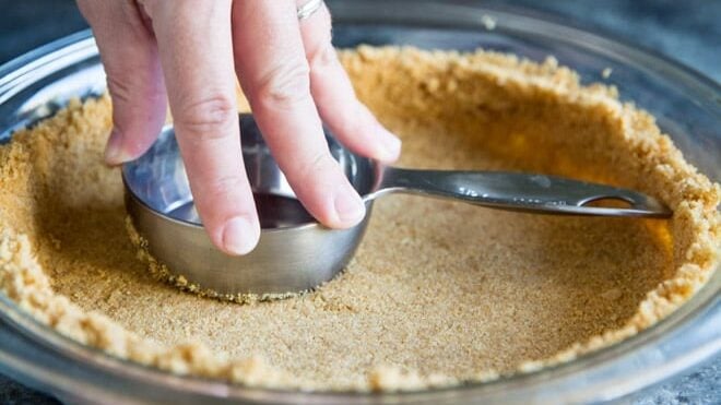 Learn how to make a Graham Cracker Crust from scratch! The homemade version is sweet, buttery, and miles ahead of anything you can buy at the store.