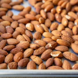 Whole almonds on a baking sheet.