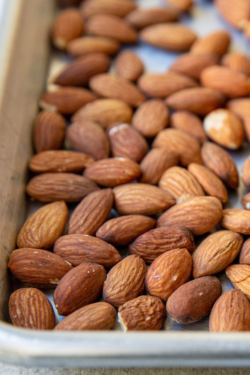 Whole almonds on a baking sheet.