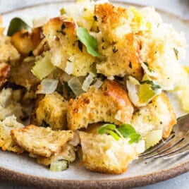 Bread stuffing on a plate with a fork.