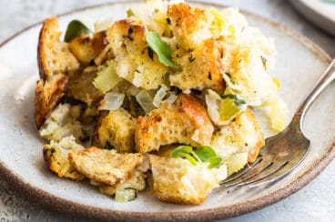 Bread stuffing on a plate with a fork.