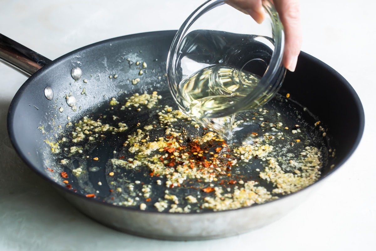 Oil, garlic and seasonings in a black skillet.