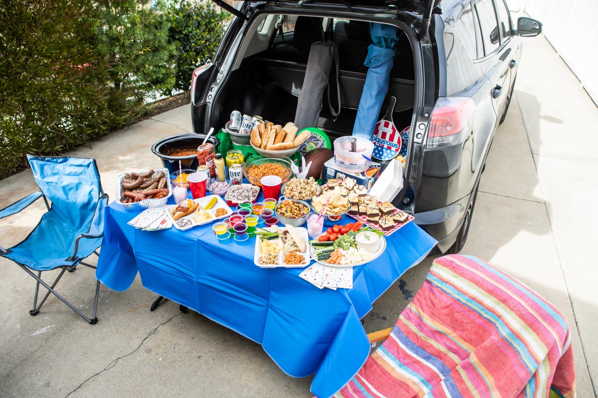 A tailgating spread set up at the back of a car.