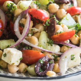 Chickpea salad on a black and white serving platter.