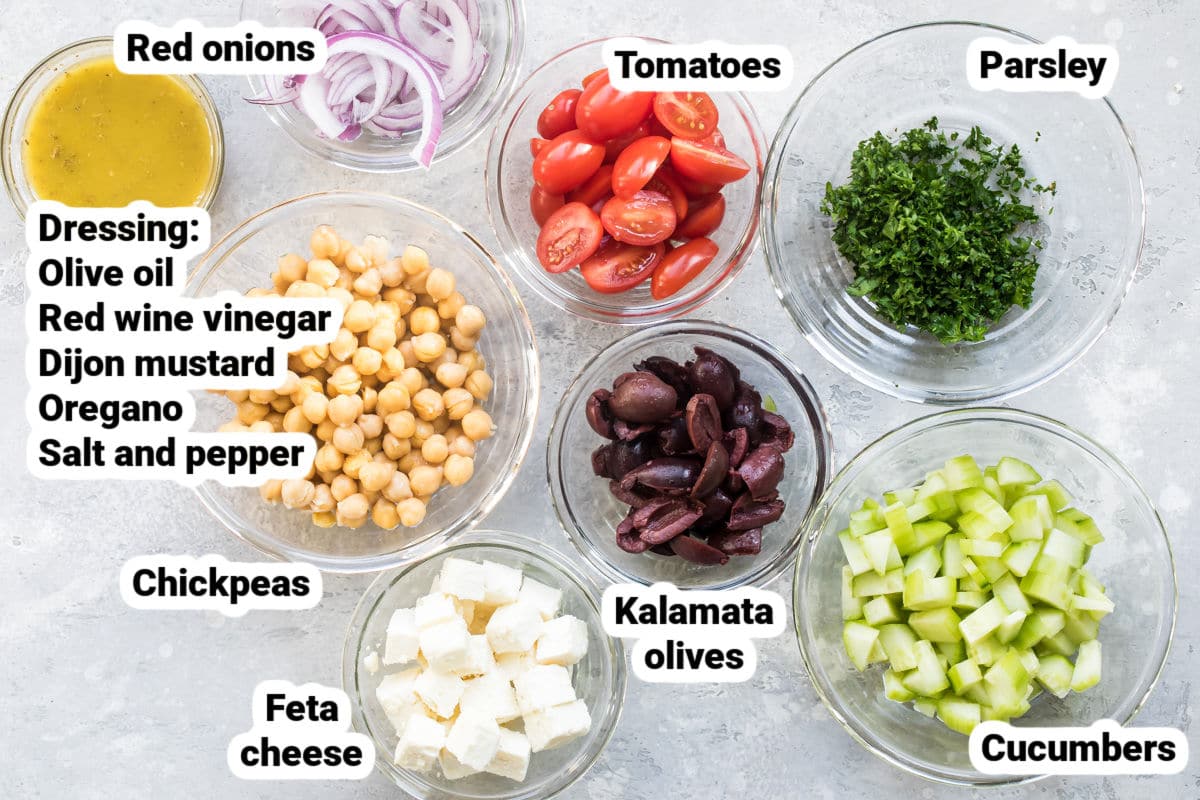 Labeled chickpea salad ingredients in bowls.