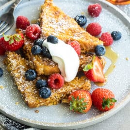 A plate of cornflake crusted french toast with fruit.