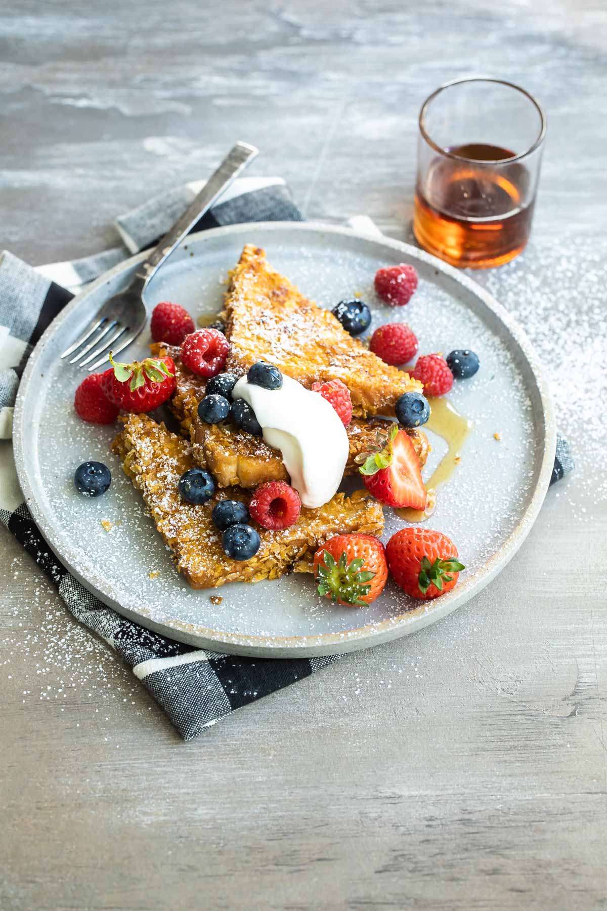 A plate of cornflake crusted french toast with fruit.