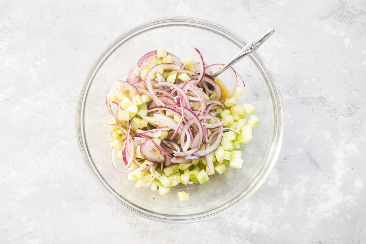 Onions and cucumbers marinating in red wine vinaigrette.