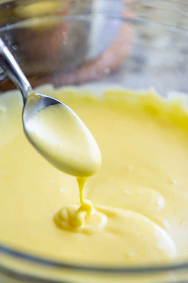 Making hollandaise sauce in a glass bowl.