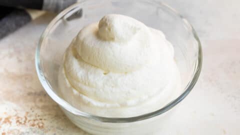 A bowl filled with piped whipped cream.