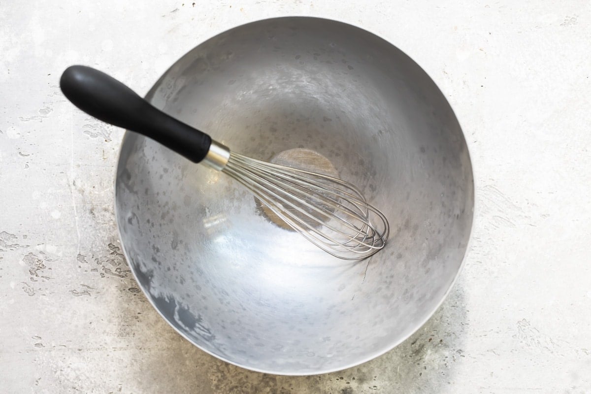 A chilled mixing bowl and whisk for making whipped cream.