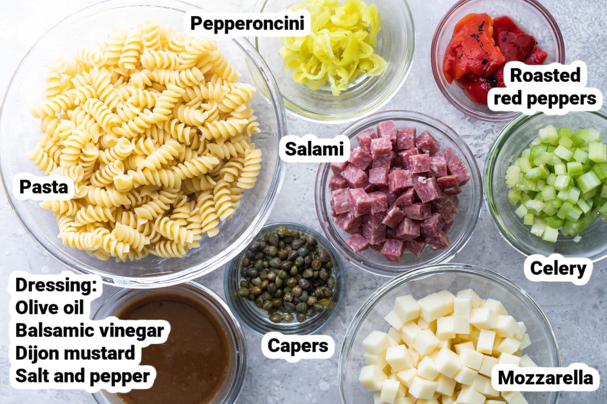 Italian pasta salad ingredients in bowls.