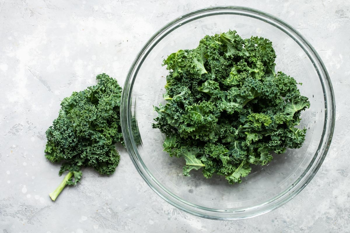 A bowl of kale torn into pieces.