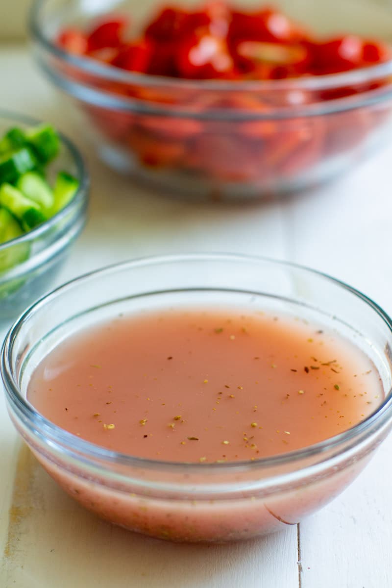 Red wine vinaigrette in a clear glass bowl.