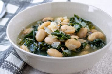White bean and kale soup in a bowl.