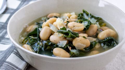 White bean and kale soup in a bowl.
