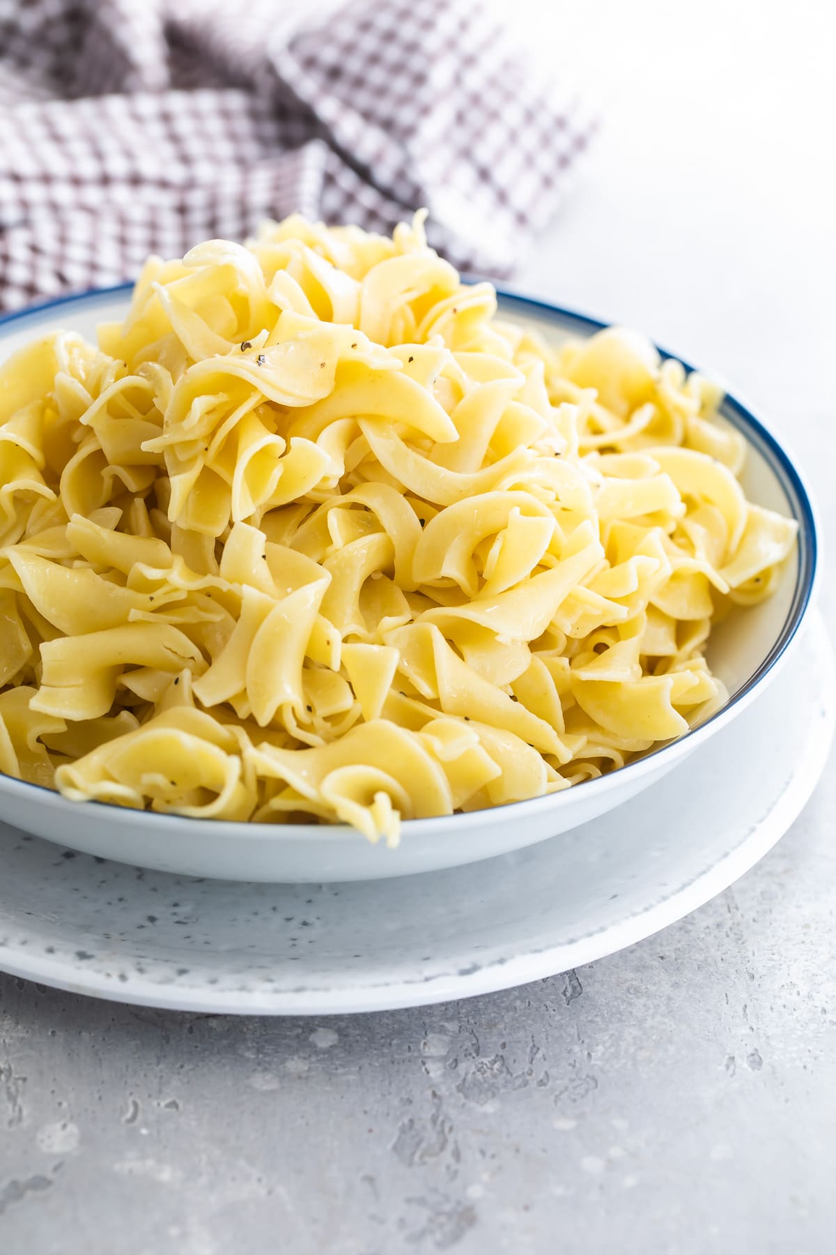 A bowl of buttered noodles.