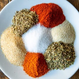 Cajun seasoning spices on a white plate.