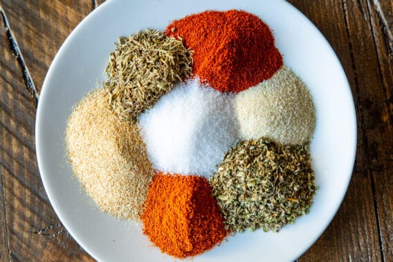 Cajun seasoning spices on a white plate.