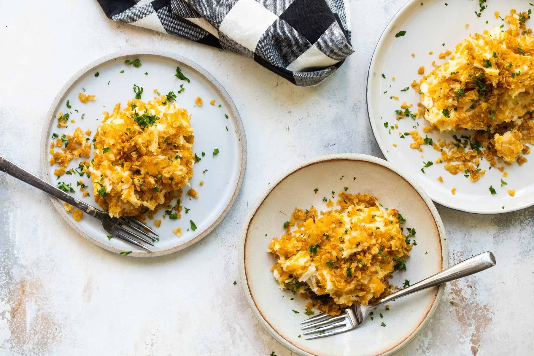A pile of cheesy potato casserole on a plate.