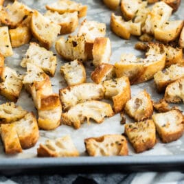 Croutons on a parchment lined baking sheet.