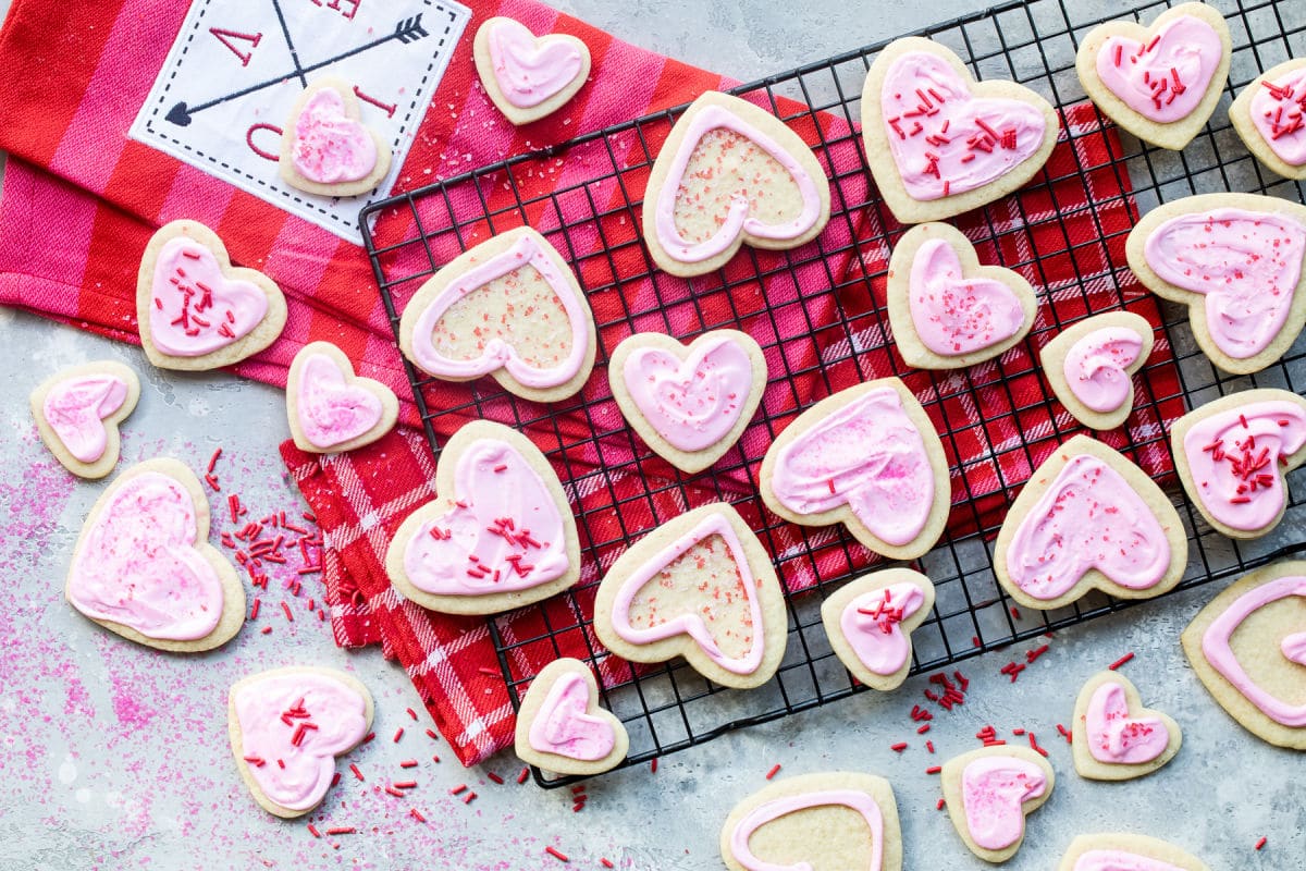Heart-shaped sugar cookies frosted with Royal Icing and sprinkles.