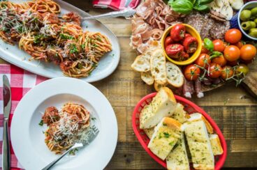 A spread of Italian food on a wooden table.