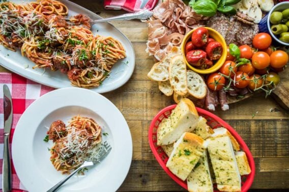 A spread of Italian food on a wooden table.