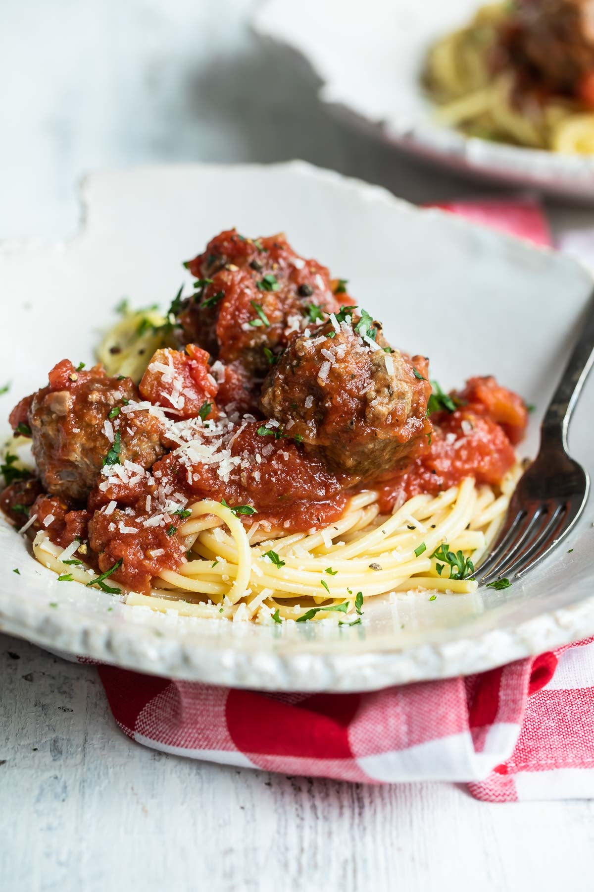 Spaghetti and meatballs on a white platter.