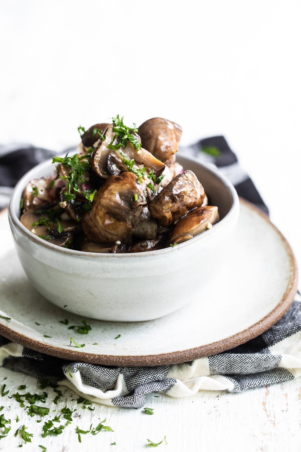 Marinated mushrooms in a gray bowl.
