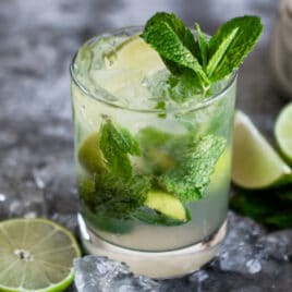 A mojito cocktail in a low-ball glass.