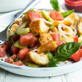Two plates with Panzanella salad.