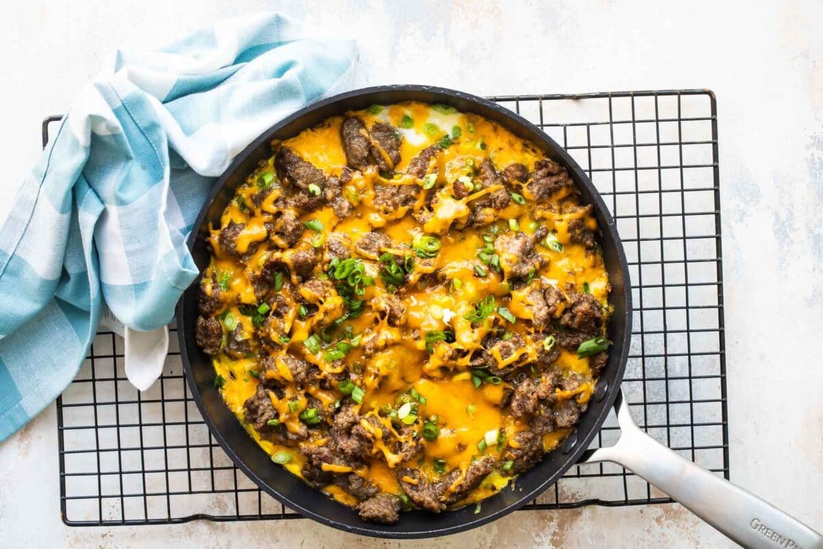 Sausage hash brown casserole in a skillet.